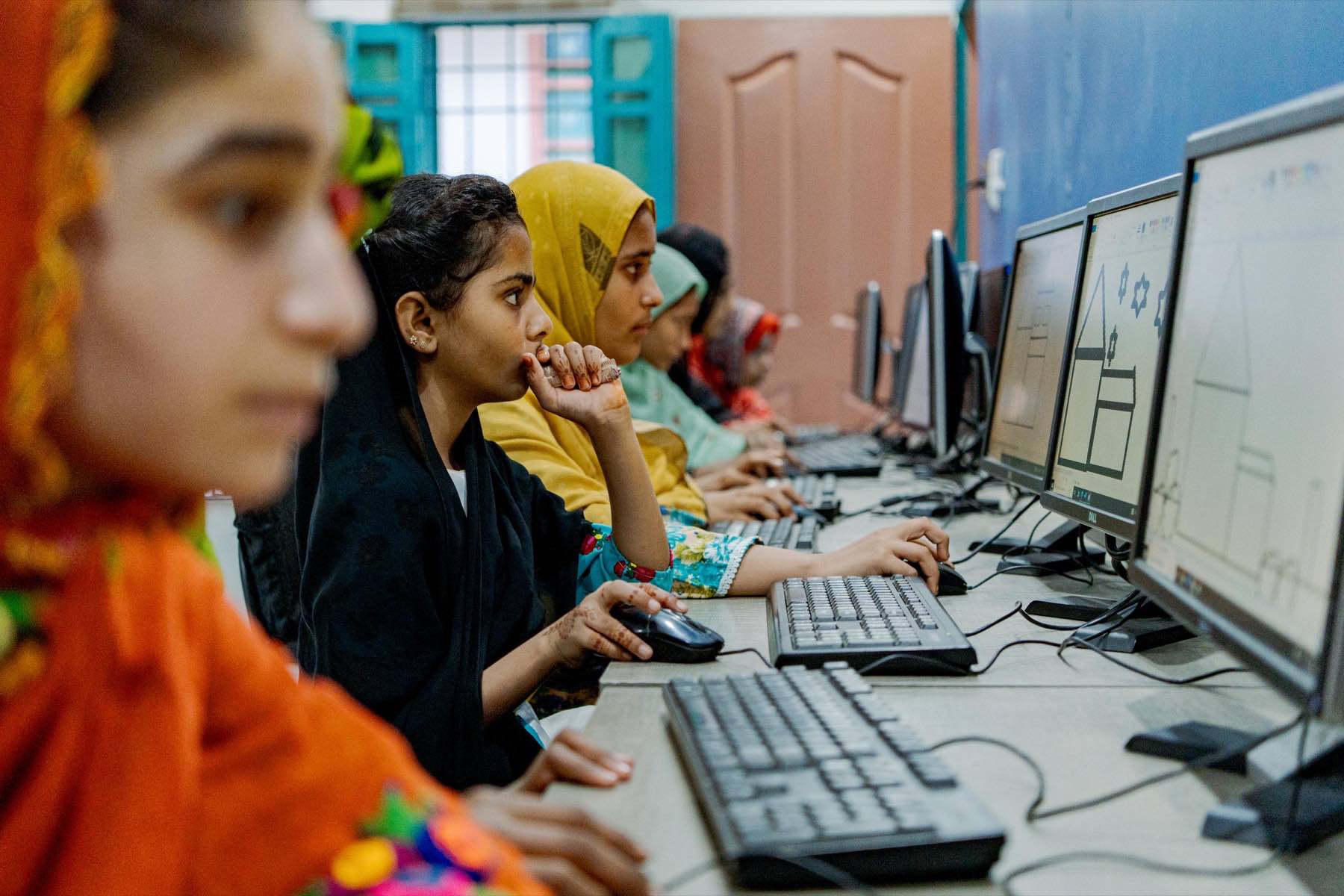 Girls learning computers at WALI digital literacy camp