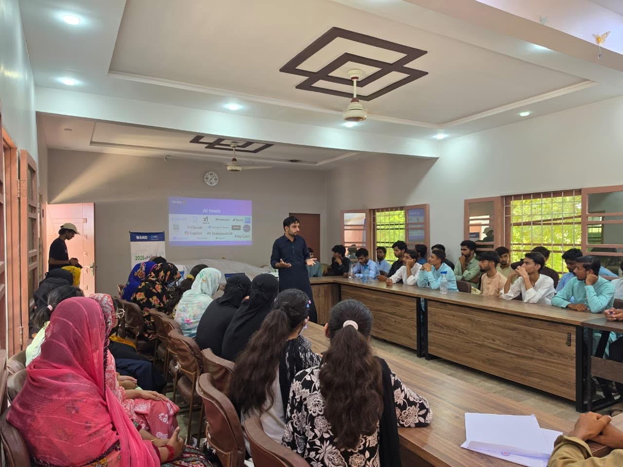 Urdu AI facilitator leading a practical artificial intelligence session for young people at WANG