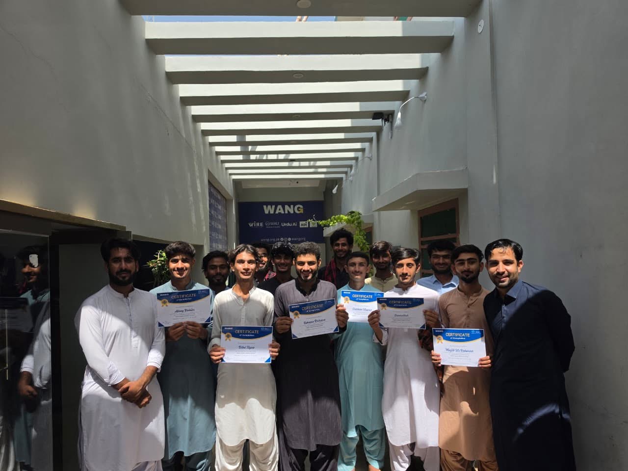 Young WALI graduates holding their skills development certificates at WANG